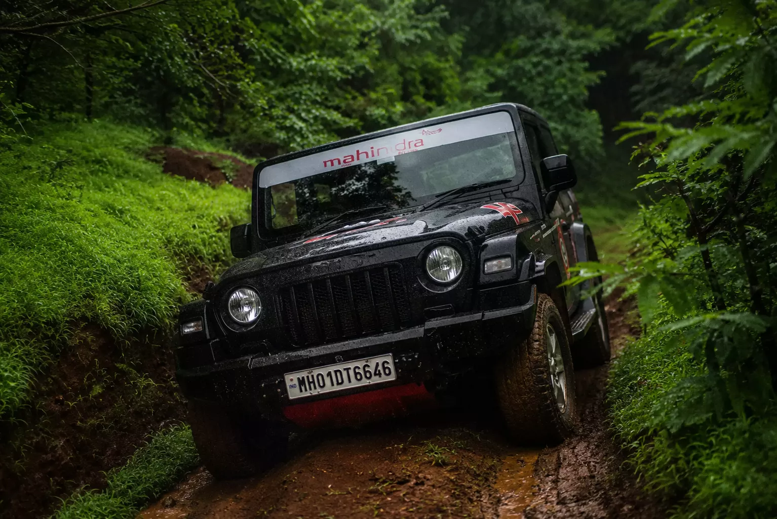Mahindra Thar 4x4 SUV conquering steep rocky terrain in Western Ghats